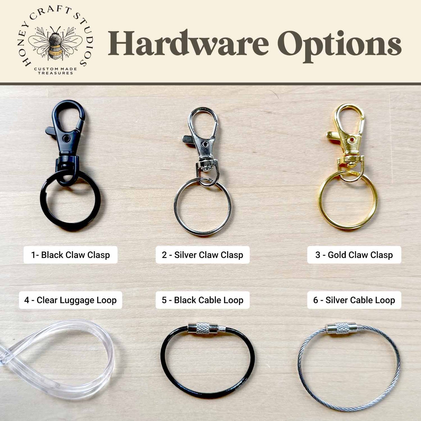 Various hardware options for keychains on a wooden surface with Honey Craft Studios branding.