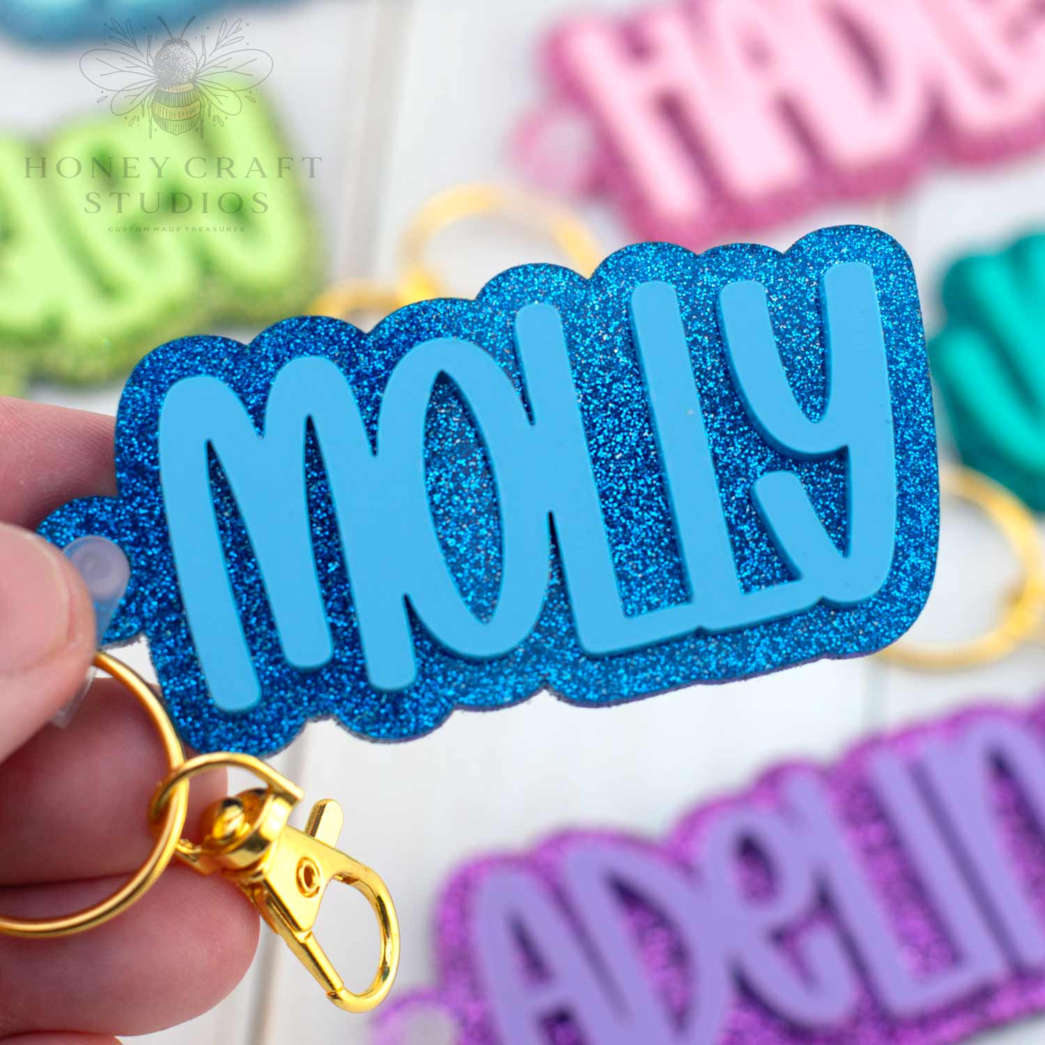 Royal blue personalized name tag keychain with glitter acrylic base, great for labeling school gear.