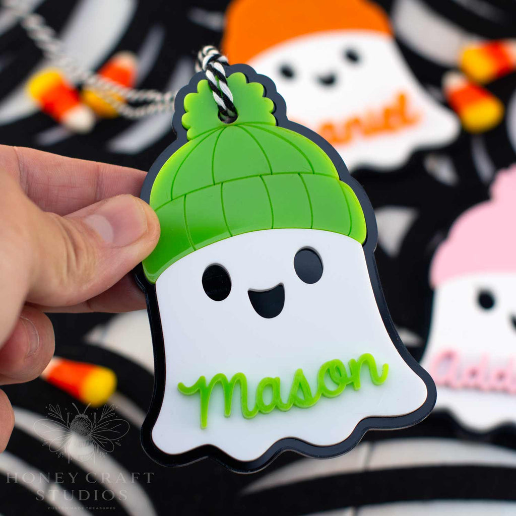 Personalized Ghost Name Tag with bright lime green beanie — acrylic Halloween keychain and custom basket tag for kids.