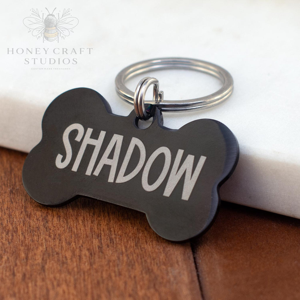 Black bone-shaped custom dog tag with engraved name Shadow and metal key ring