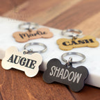 Silver and black personalized bone dog tags with engraved names Augie and Shadow