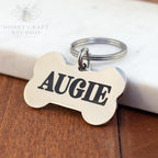 Silver bone-shaped dog tag engraved with name Augie and attached key ring