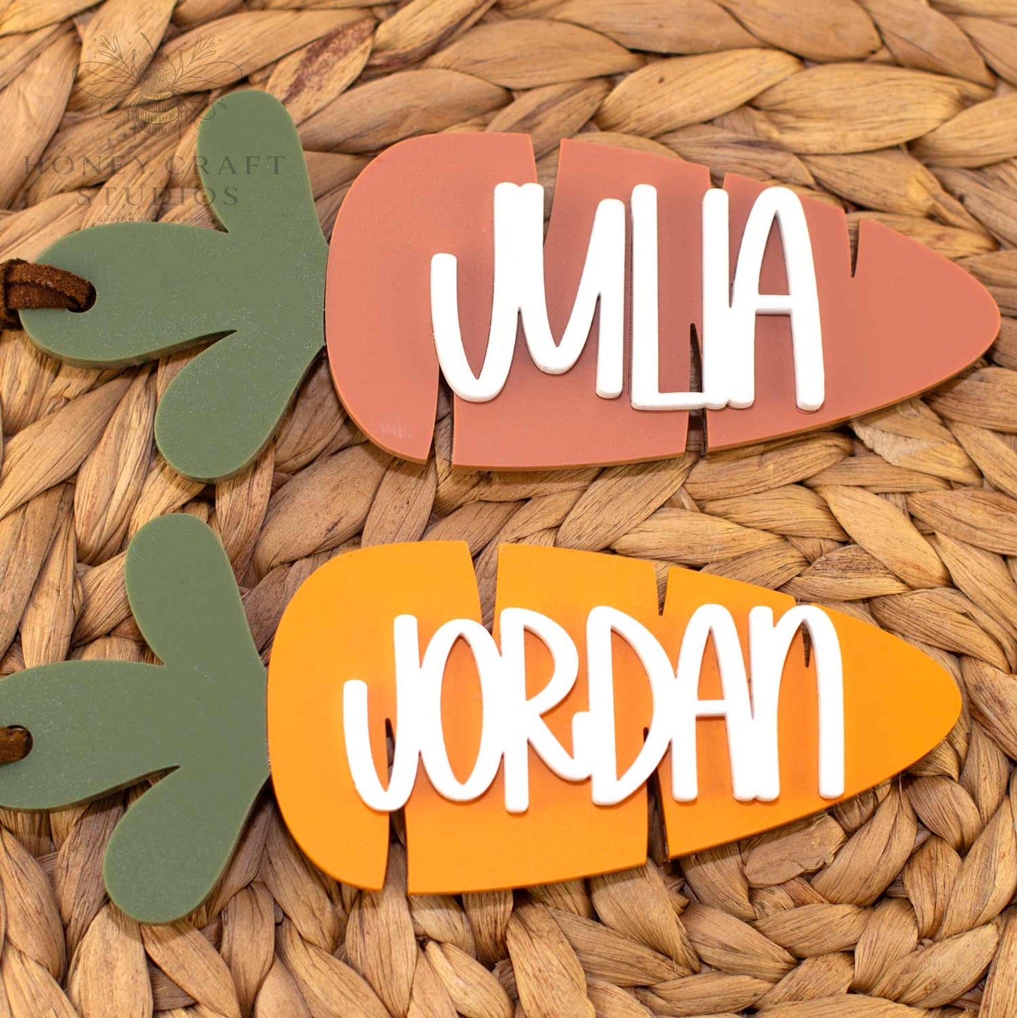 Personalized Easter basket carrot name tags with layered acrylic design and raised names, shown in terracotta and bright orange