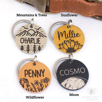 Personalized stainless steel pet ID tags available with Mountains & Trees, Sunflower, Wildflower, and Moon engraved designs in silver, gold, copper, and black finishes.