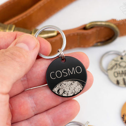 Personalized stainless steel pet ID tag with moon engraving and custom name Cosmo in a black finish, deep engraved dog and cat identification tag.