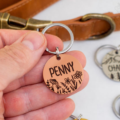 Personalized stainless steel pet ID tag with wildflower engraving and custom name Penny in a copper finish, deep engraved custom dog tag.