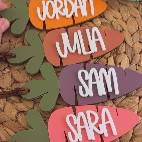 Custom acrylic carrot Easter basket tags with raised white names in assorted colors made by Honey Craft Studios
