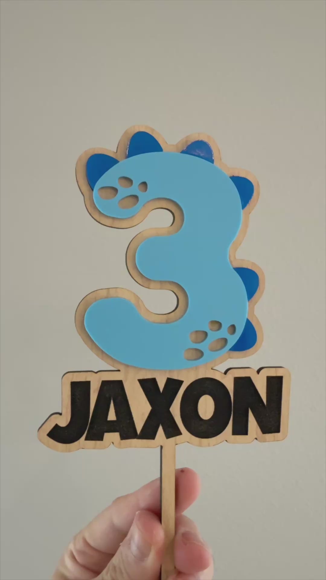 Dinosaur number and name cake topper made from wood and acrylic for a personalized kids dinosaur birthday cake. Made by Honey Craft Studios.