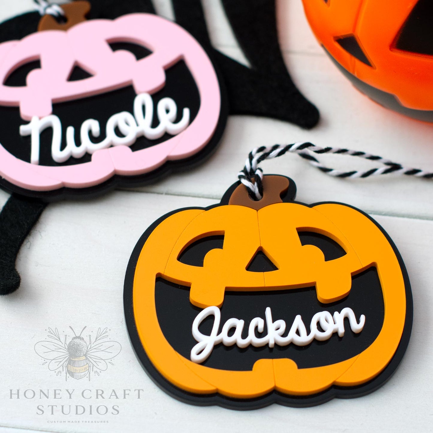 Halloween-themed name tags with 'Nicole' and 'Jackson' on a white background, featuring the Honey Craft Studios logo.