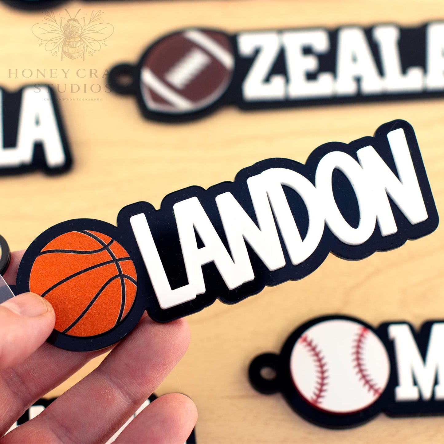 Close-up of custom basketball name tag for kids, reading “LANDON” with an orange basketball icon, perfect for backpacks or sports bags.