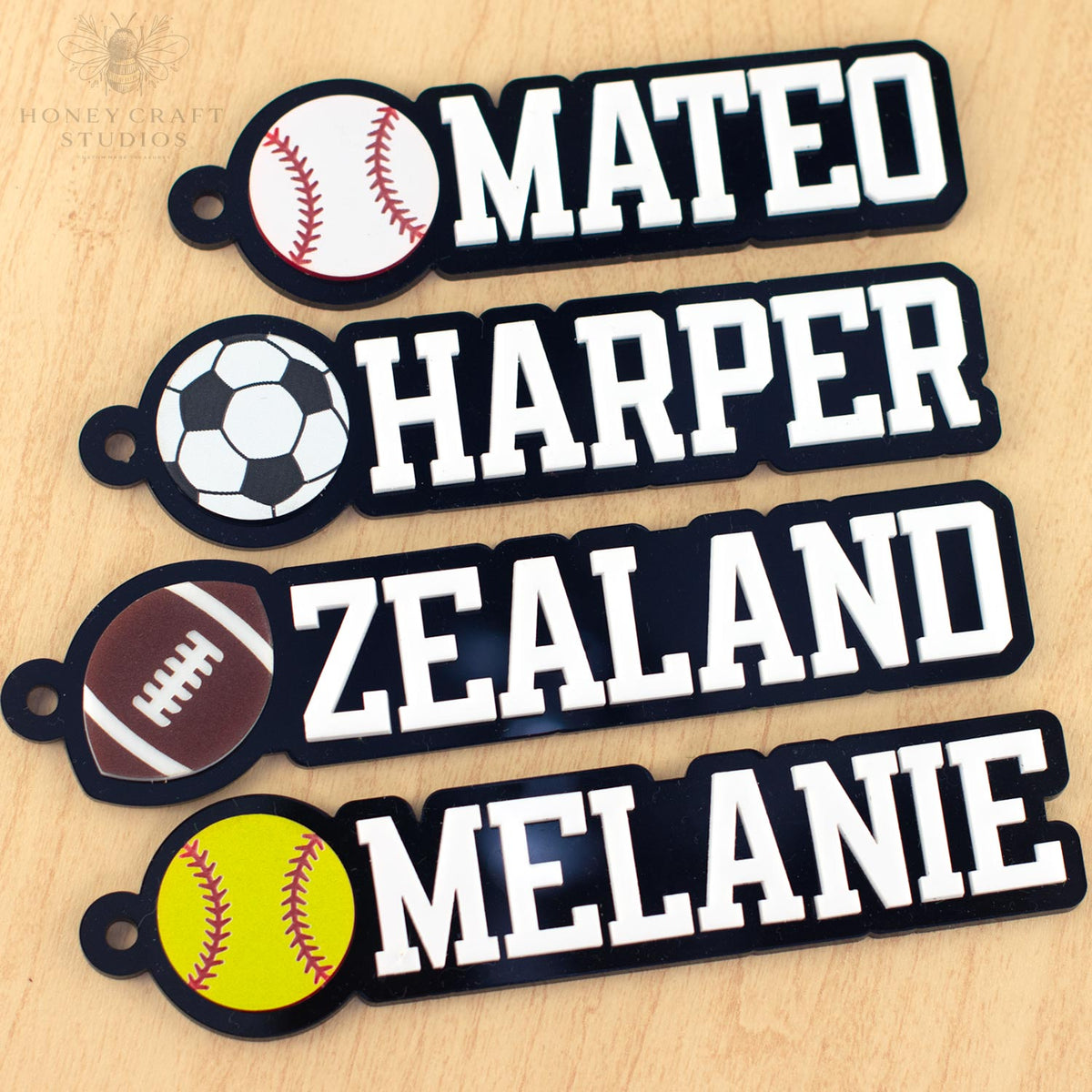 Custom name tags for kids featuring sports icons like baseball, soccer, football, and softball with names including Mateo, Harper, and Melanie.