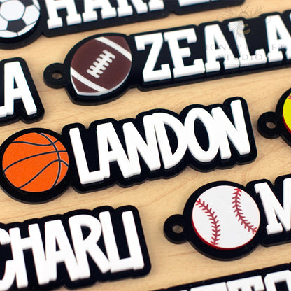 Custom basketball name tag for sports bags with the name “LANDON” in white letters next to a bold orange basketball.